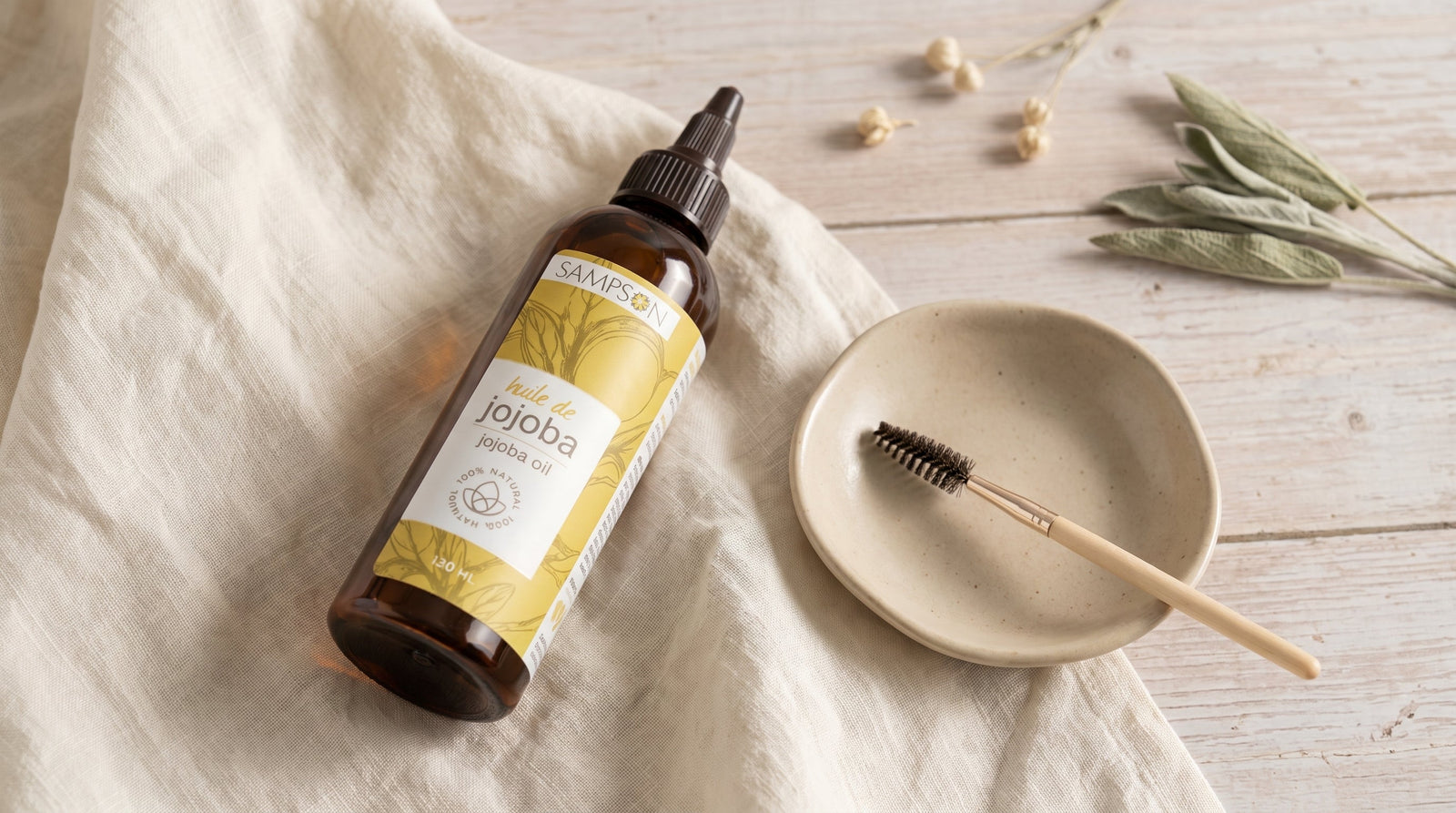 Pure Jojoba Oil bottle styled for lash and eye-care use, editorial eco-luxury scene