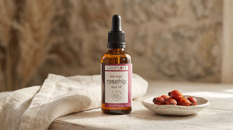 Sampson Rosehip Face Oil bottle with dried rosehips, editorial skincare scene